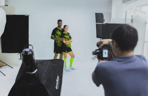 Models posting in front of camera in studio