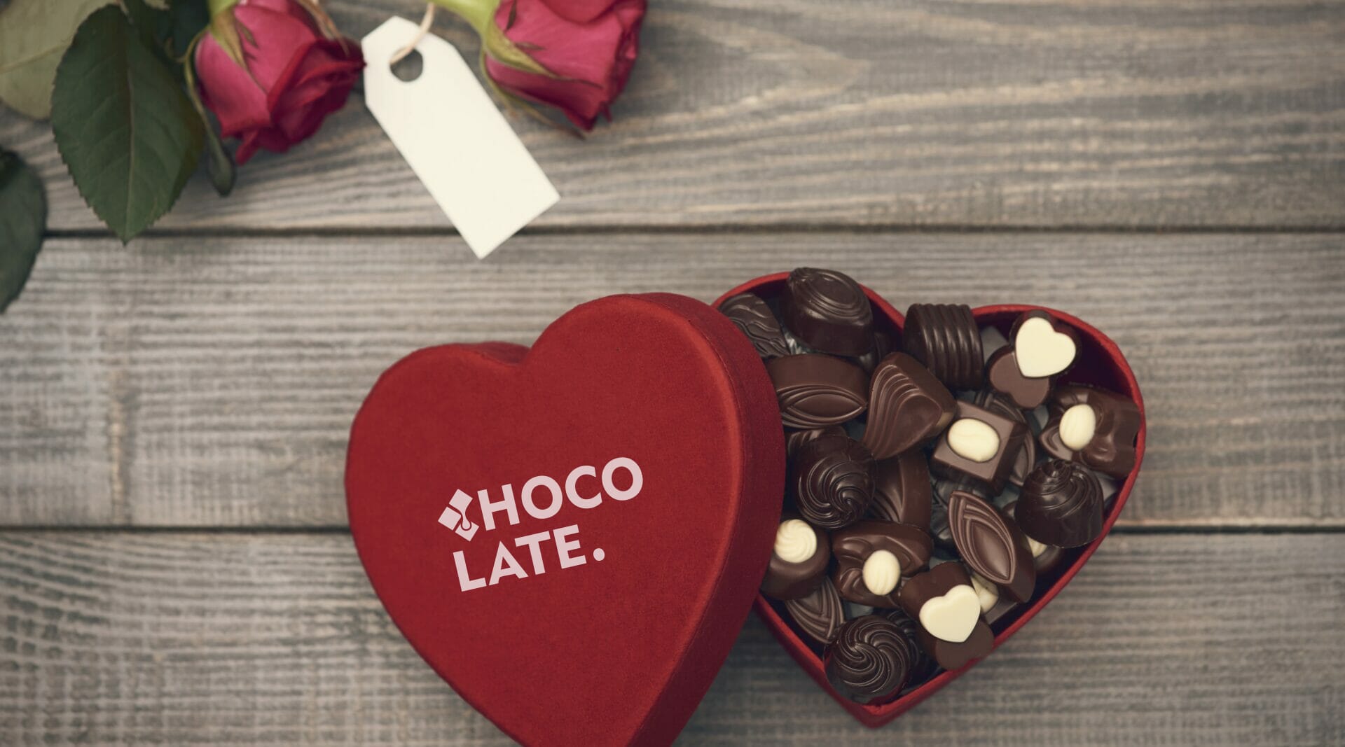 Heart-shaped red box filled with assorted chocolates and branded with “CHOCO LATE.” logo for custom chocolate packaging