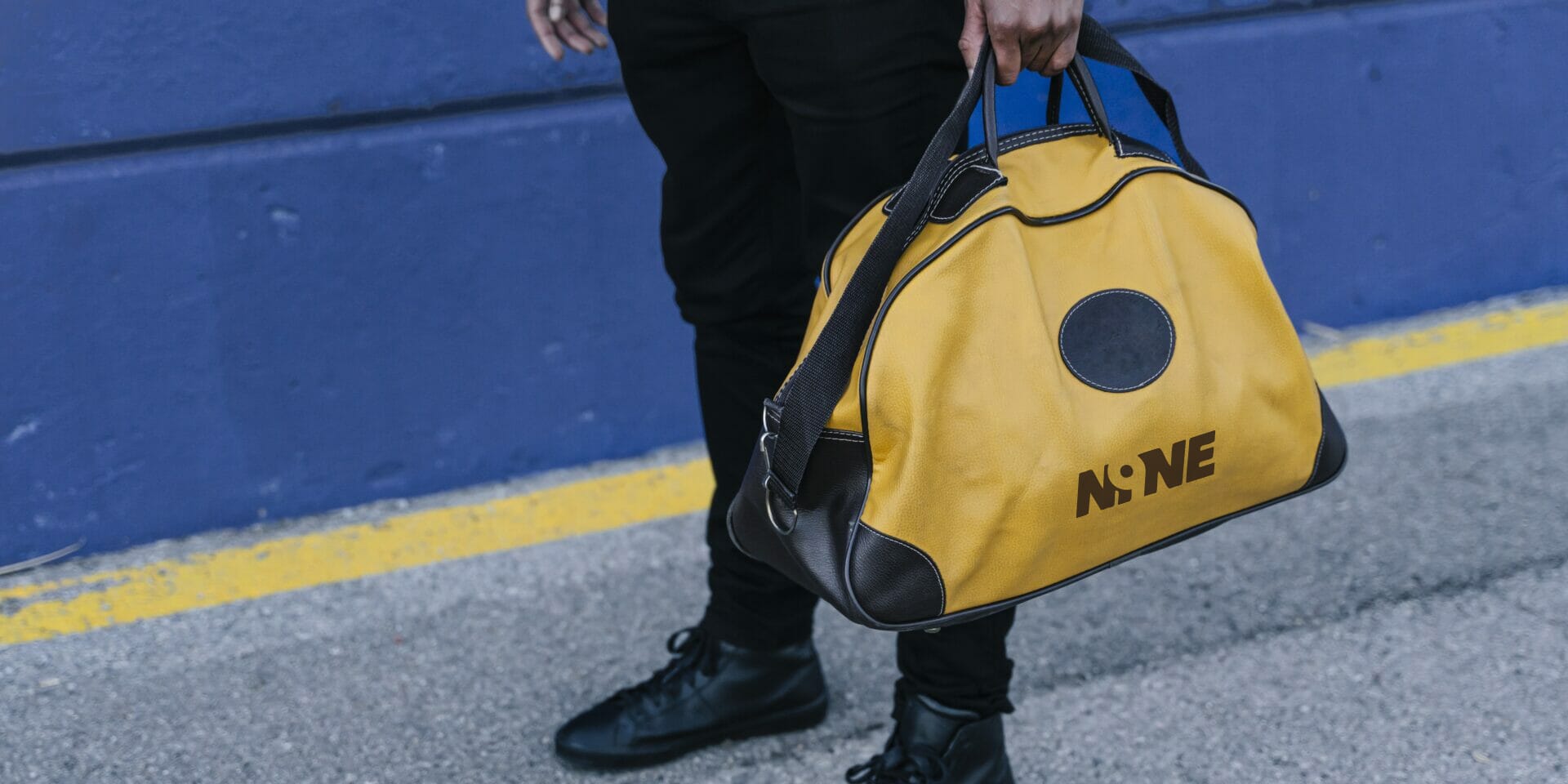 yellow and black custom duffle bag with the logo “NINE,” showcasing a stylish branded travel and sports duffle bag design.
