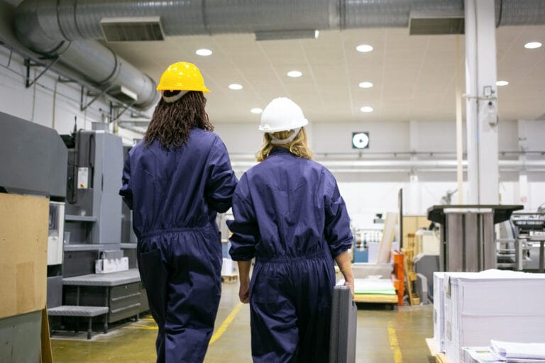 two femal factory workers are conducting quality control and assurance