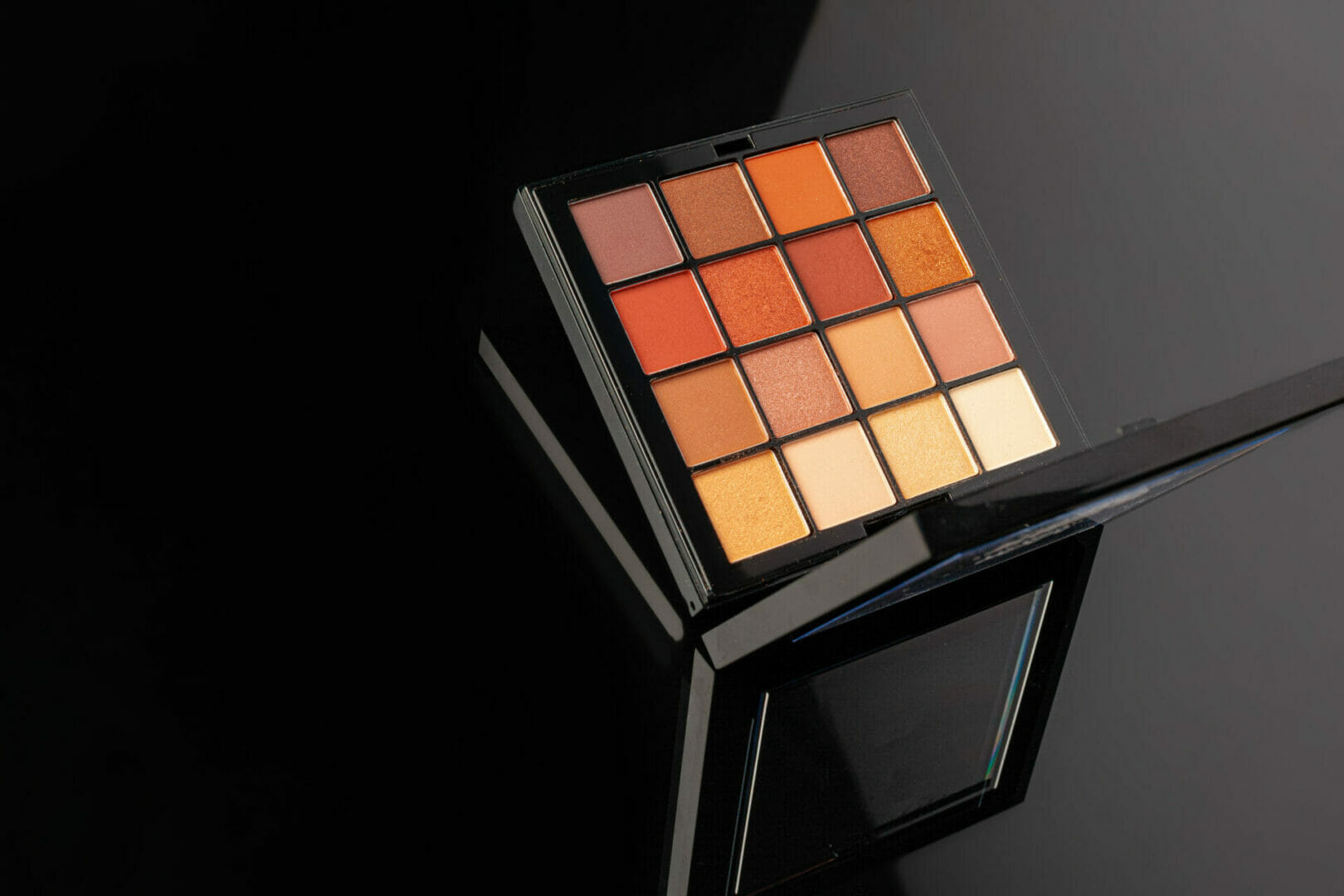 Black makeup palette filled with vibrant colors for different eyeshadow cases.
