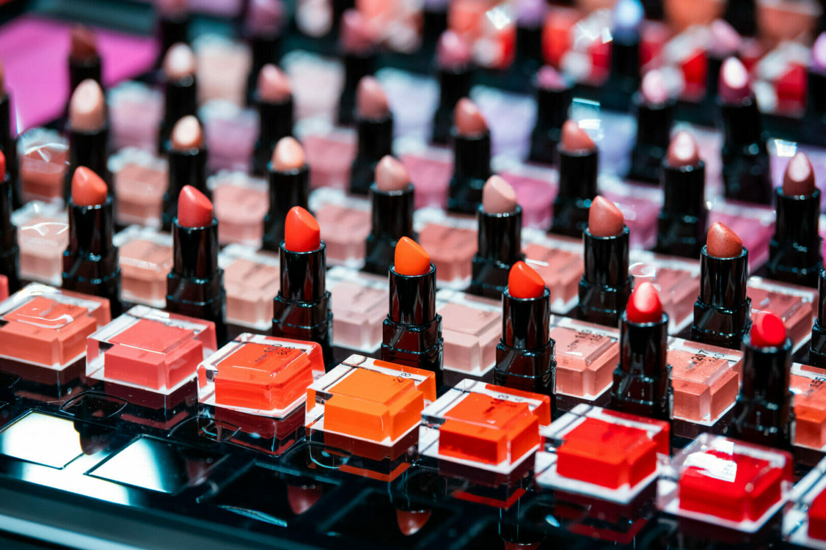 Rows of diverse lipstick tubes in various shades.