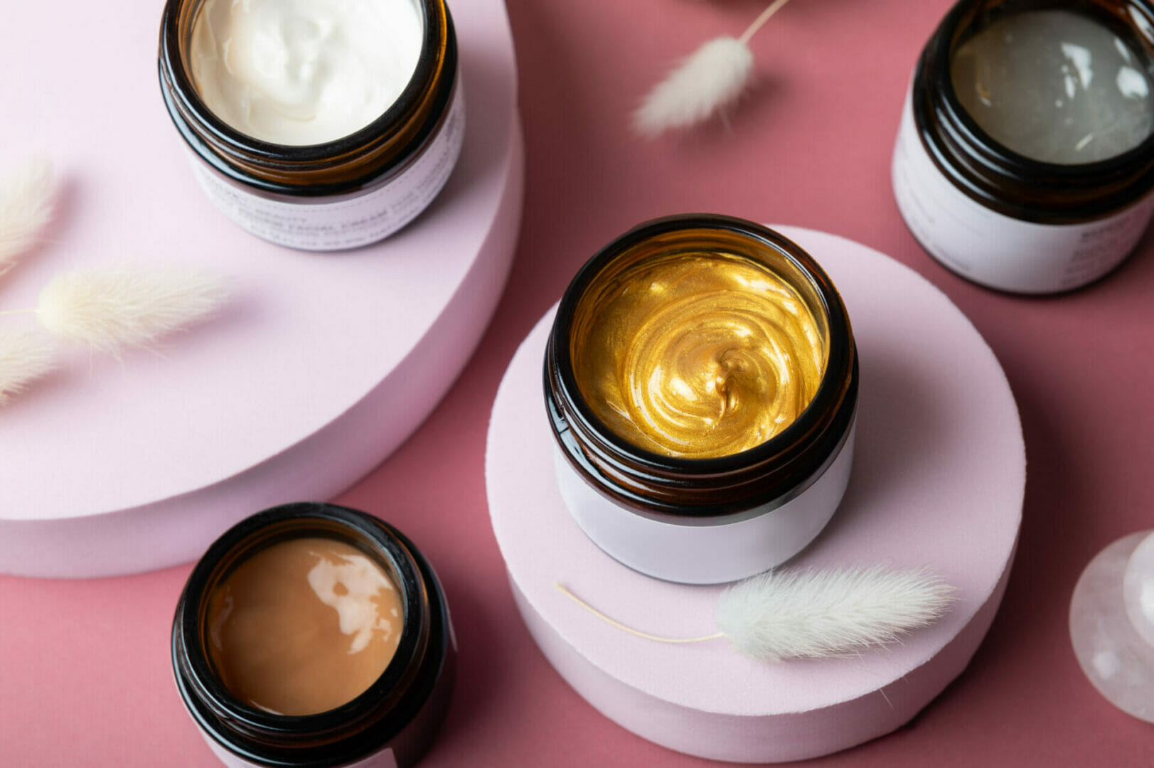 Open custom cosmetic jars filled with skincare creams