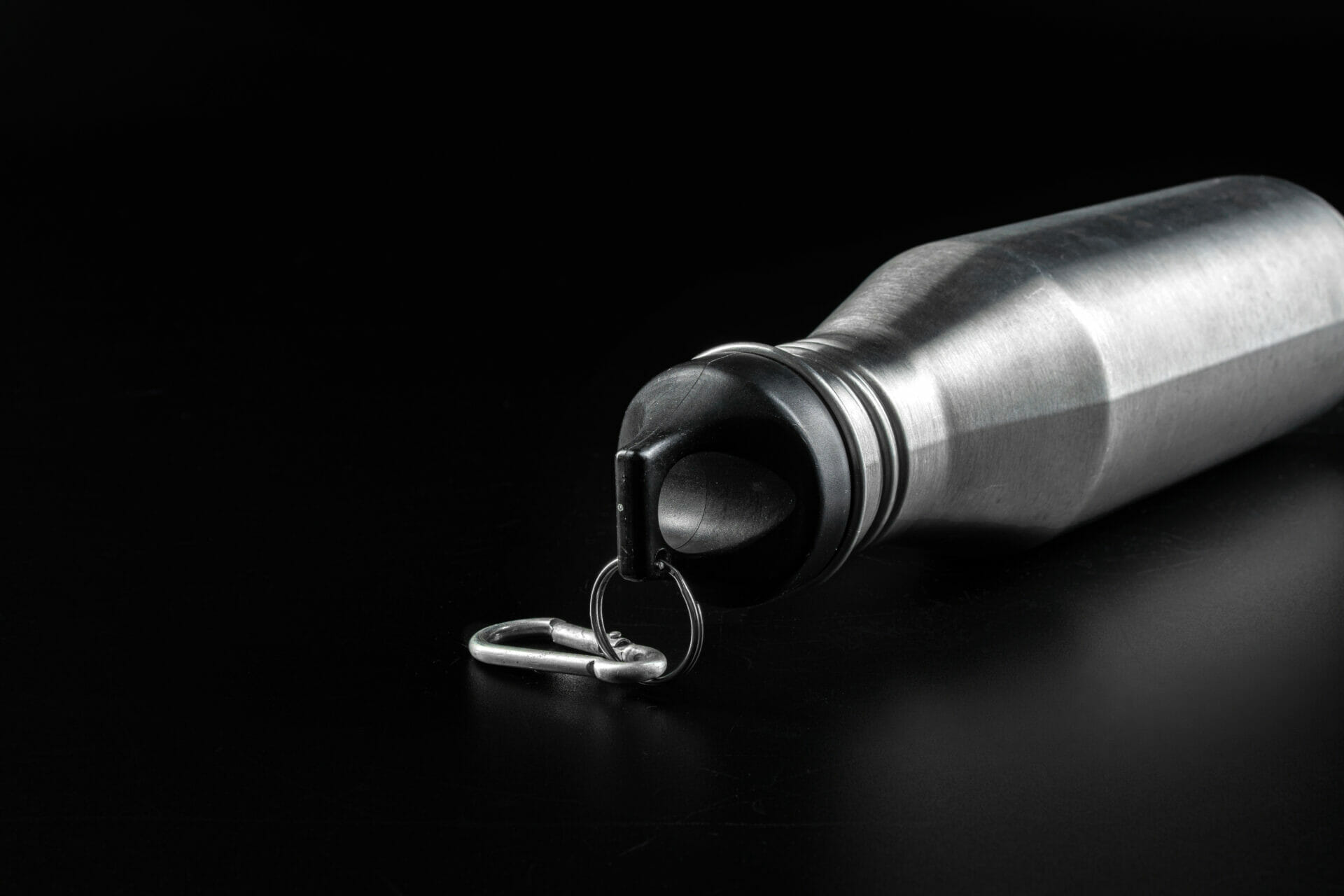 Reusable silver bottle with a black lid for drinks