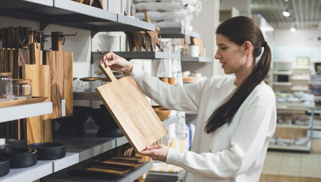 Customer browsing various kitchen utensils thoughtfully arranged in custom retail displays.