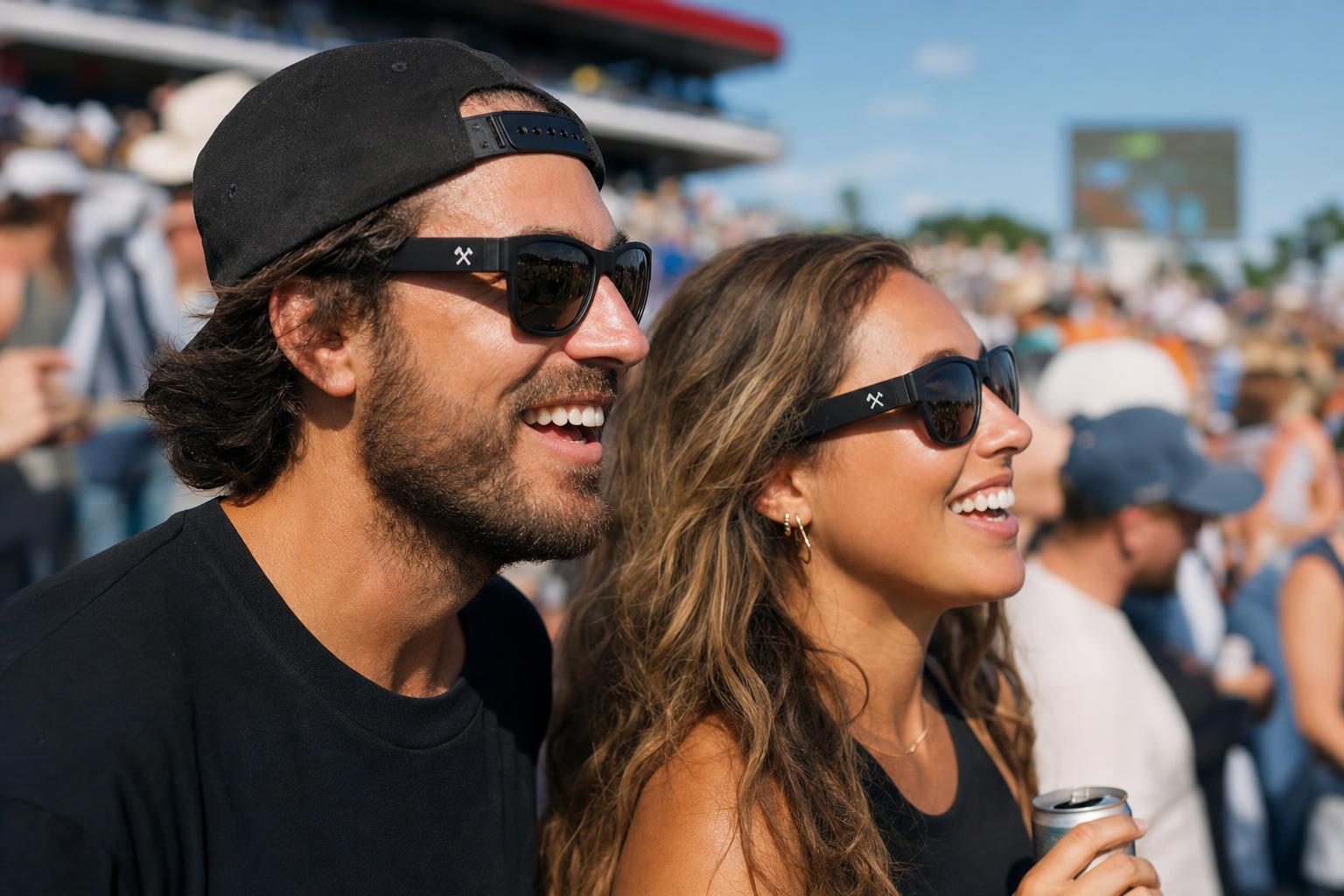 Custom branded sunglasses with a logo printed on the arm, worn at an outdoor event.