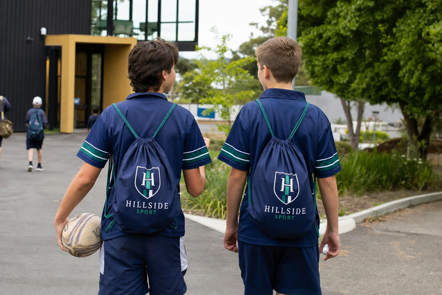 Students carrying custom branded drawstring bags with a printed school logo.